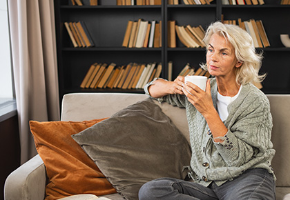 woman drinking coffee thinking about condominium reserve funds
