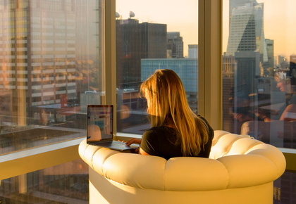 woman researching condo vs apartment on laptop