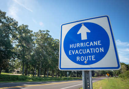 Hurricane sign next to street with trees behind - FirstService Residential