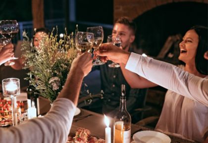 A group of people around a table toast at a community event