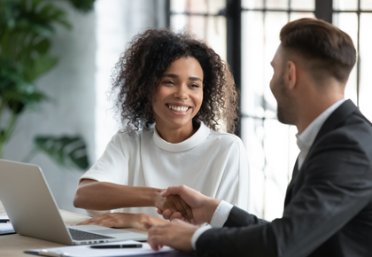 Two business people shaking hands after conflict resolution