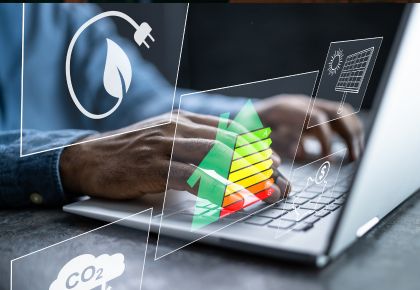 Hands at a laptop with virtual images of energy consumption