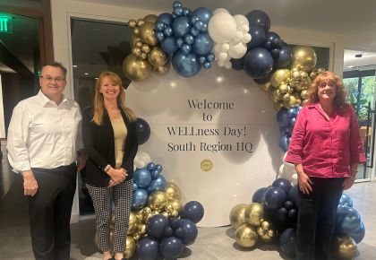 South Region leadership in front of the WELLness Day welcome sign
