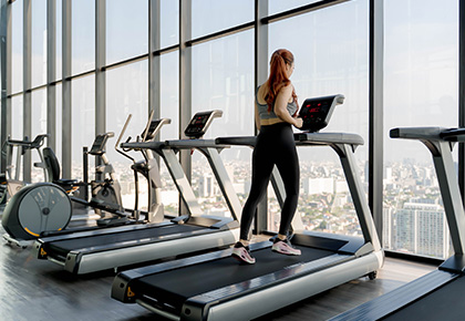 Resident running on a treadmill in a Boston's high-rise bulding