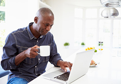man on laptop with coffee
