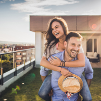 Fun couple at high-rise rooftop deck