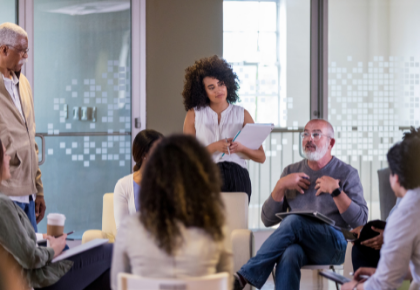 Group of people having a discussion at a board meeting