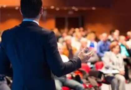 A man presents at an annual meeting