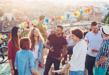 A group of young people enjoy a community event on the rooftop