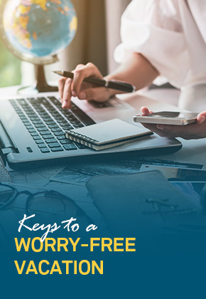 Woman working on laptop and phone - FirstService Residential