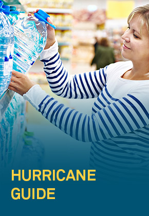 Woman in sweater with strips getting a bottle of water from a shelf - FirstService Residential