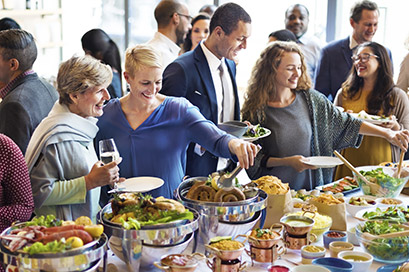 People getting food at a comunity party - FirstService Residential