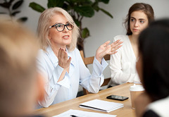 Woman with glasses in a meeting - FirstService Residential
