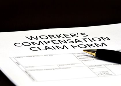 Worker's compensation claim form with pen
