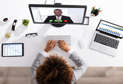 Woman sitting at desk with computer - FirstService Residental